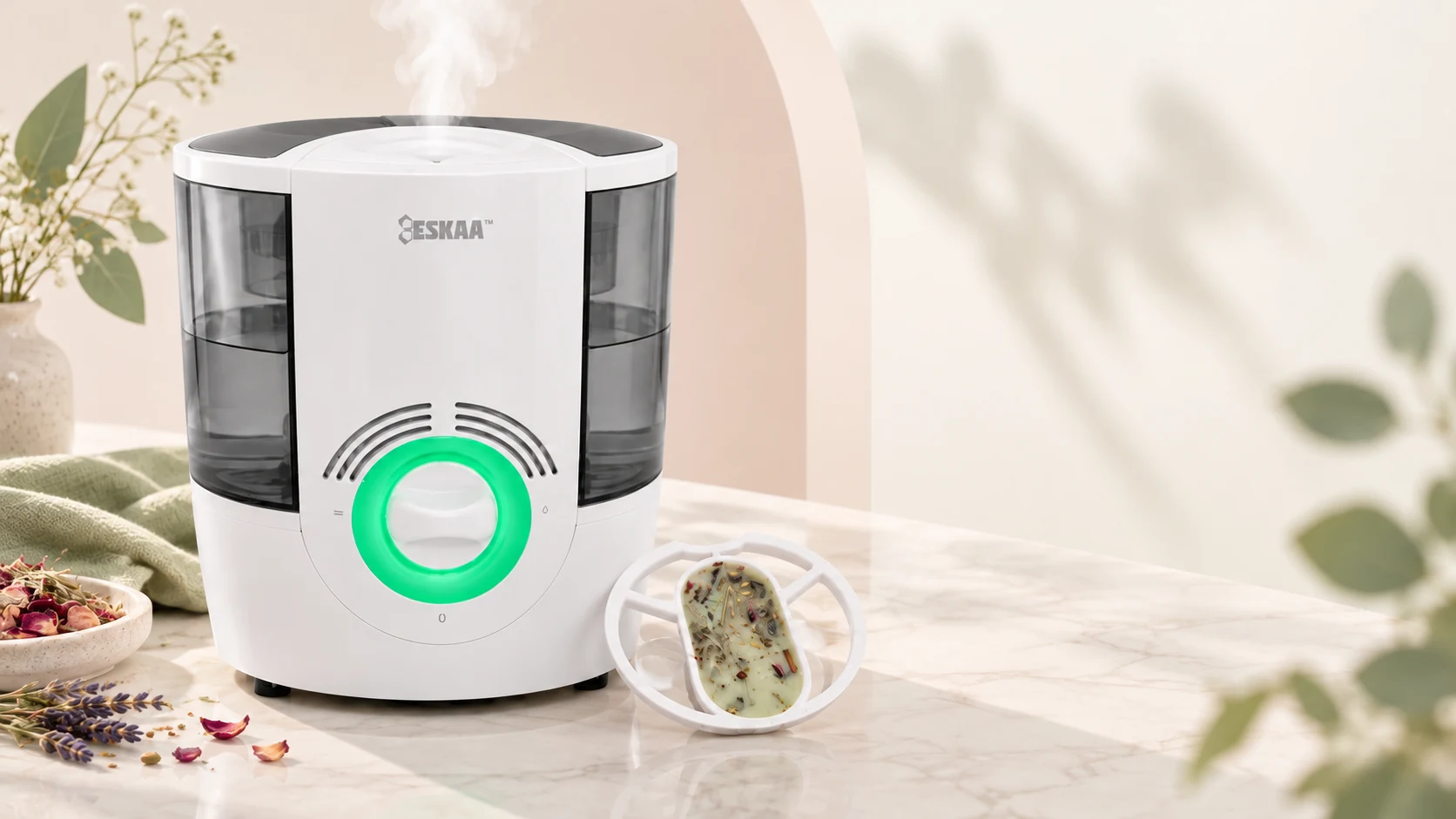 Eskaa white heated humidifier with illuminated green dial and a botanical wax fragrance tray beside it